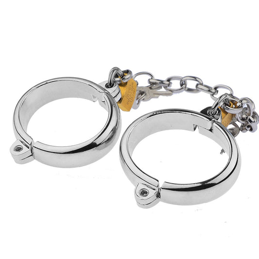 “Steel Submission Shackles” – Solid steel handcuffs. Cold and unyielding—just how your purpose should be.